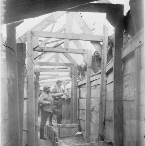 A well-constructed trench revetted with planks. Note the grenade blocks protruding above the trench. 