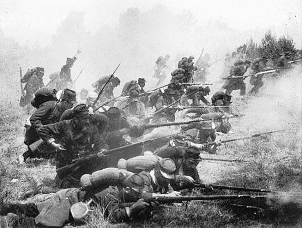 Likely a posed but dramatic action scene. Nonetheless, the image is effective in giving the viewer an idea of fighting in 1914.