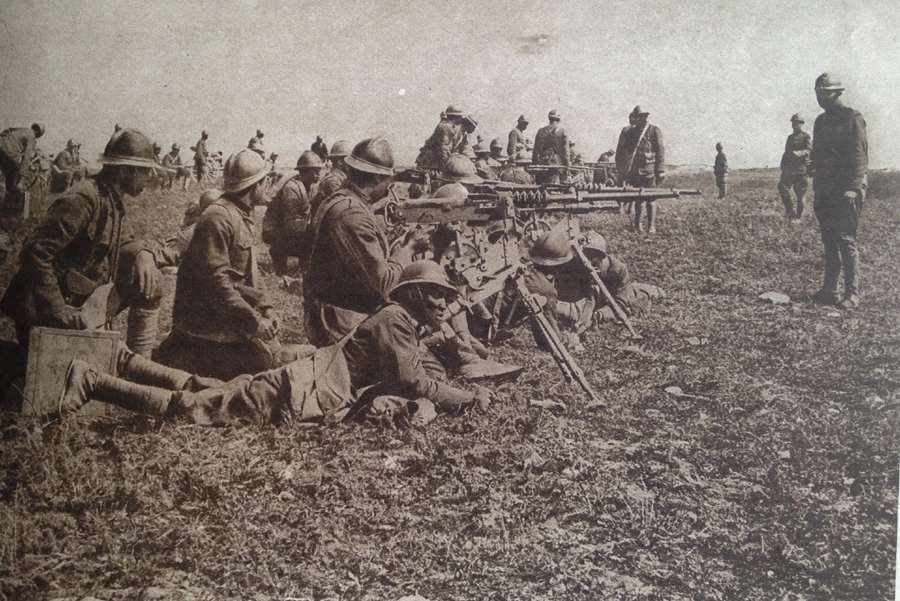 These are black American troops, who served in US army units assigned to French divisions, receiving machine-gun instruction from French instructors in July 1918. Note also their French equipment.