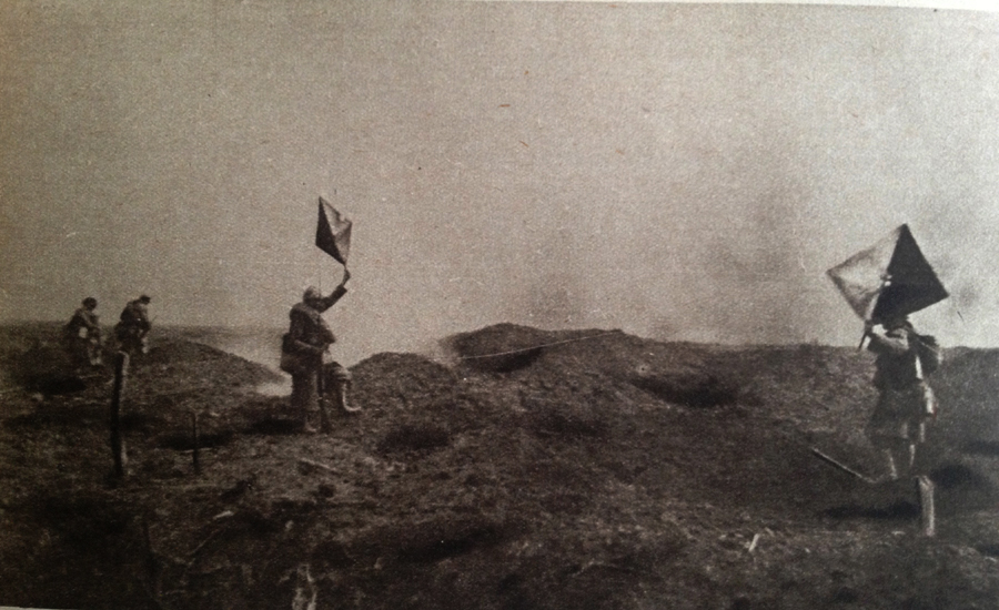 Photo taken during the assault on Dompierre (Somme) 1 July 1916 and showing two signal men using semaphores to signal to artillery observers.