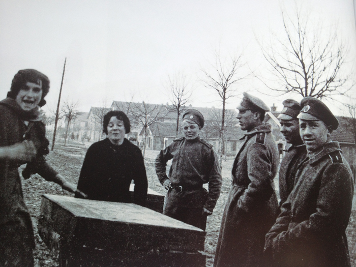 A group of Russian soldiers of the Russian Legion bargain over prices with two French ladies. Photo taken by Frantz Adam, near Viller-Franqueux, March 1917.