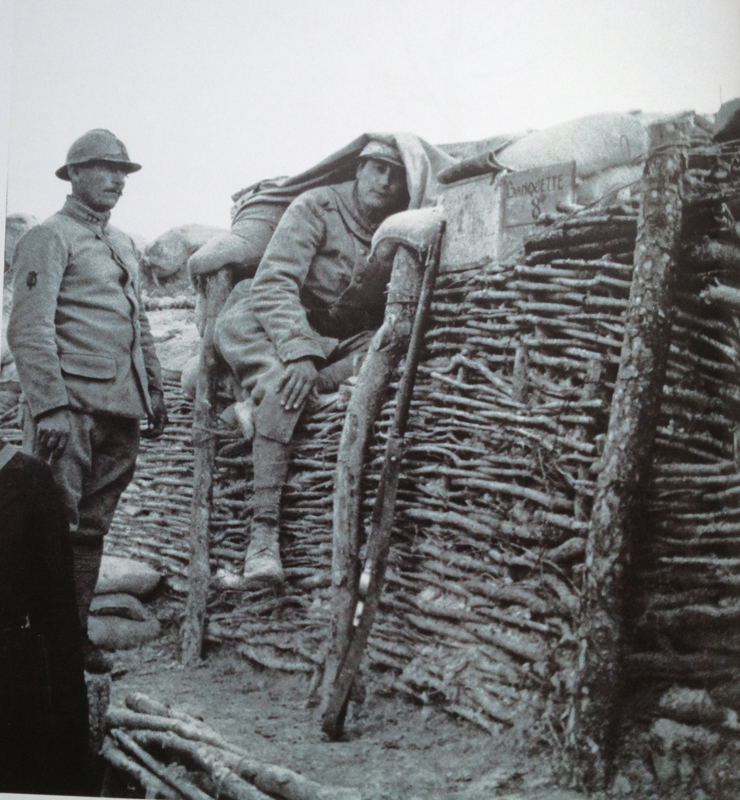 A soldier manning an observation post camouflaged by using a simple tent-canvas. Photo taken by Frantz Adam, July 1917.