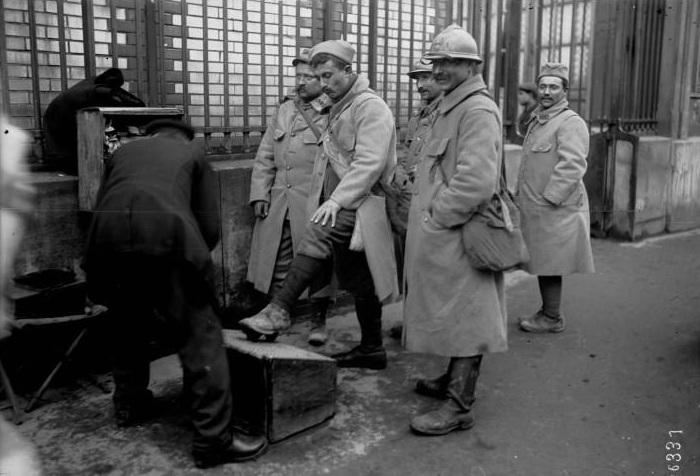 Soldiers on furlough in Paris, getting shoe shines.