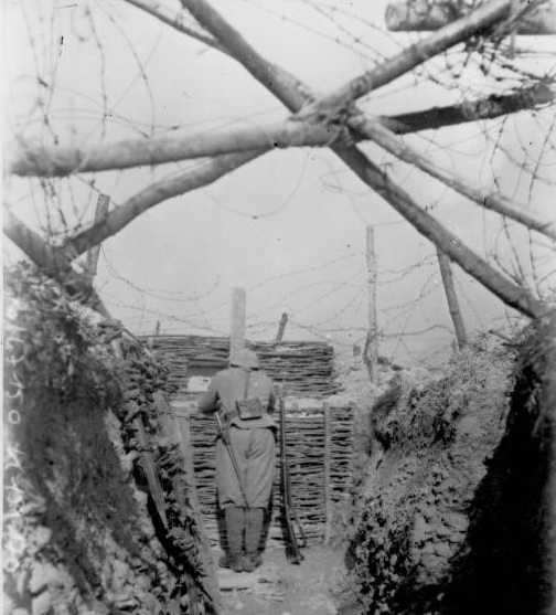Barbed-wire can be seen stretched across a trench to defend against infiltrators.