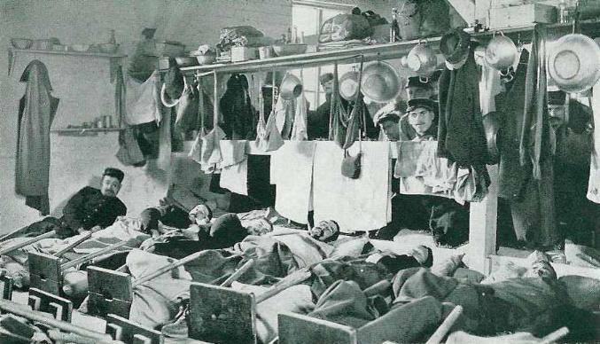 French POWs chained in place in their barracks at Camp Darmstadtdortoir, Germany, 1914.
