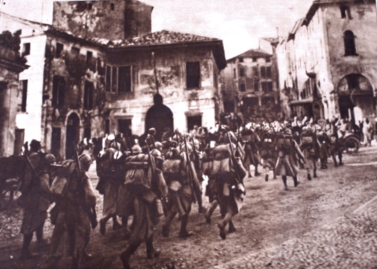 French troops march through an Italian villa as part of the French expeditionary force.