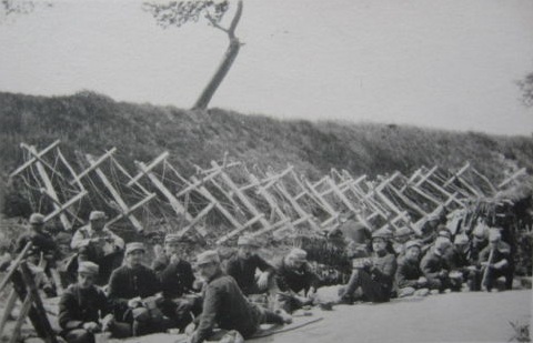 Soldiers rest next to a row of 
