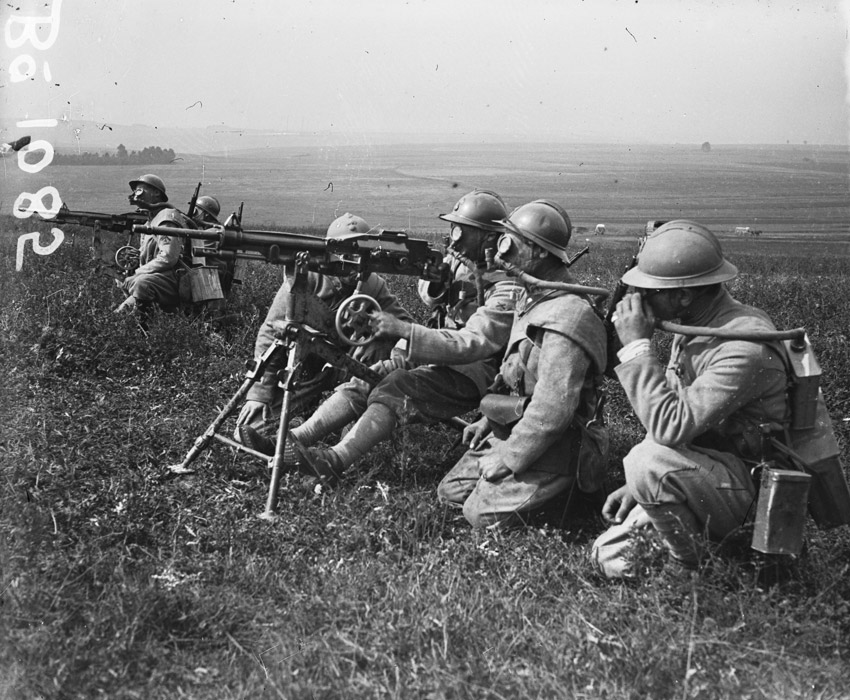 Machine-gunners on training operations wearing Tissot gas masks. (1916)