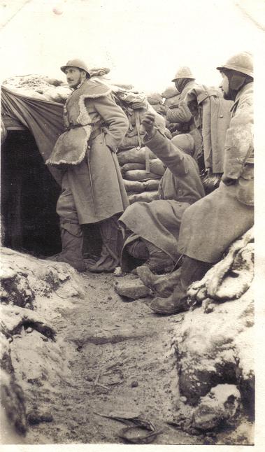 A somewhat posed shot in an advanced post, with soldiers wearing winter gear including sheepskins and trench boots.