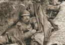 A poilu sits in his trench abode.