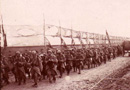 A regiment marched along a road camouflaged be canvas screens near Glennes.