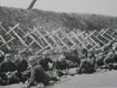 Soldiers rest next to a row of 