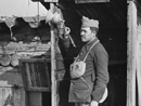 A man stands at the ready next to a gas alarm.