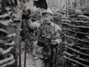 A soldier in the Parcy Forest in a gas alarm exercise, donning a P@ pad and goggles.