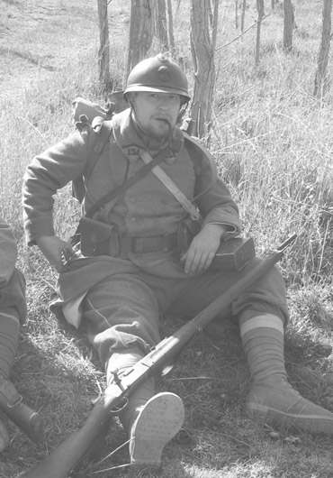 Cpl. Picard takes a moment to get off his feet and have a pipe after morning formation, April 2005.