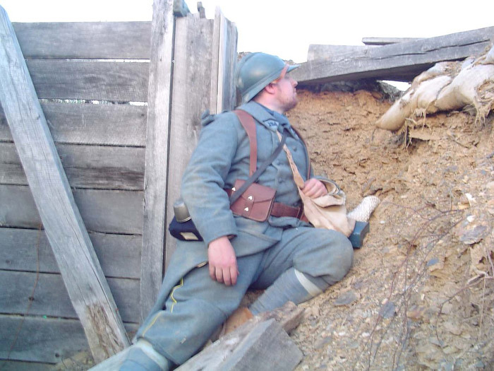 Cpl. Picard peers through a loophole to keep an eye on the enemy, April 2005.