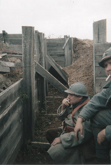 Sdts. Fagot and Hauser have a smoke next to a collapsed section of trench, April 2003.