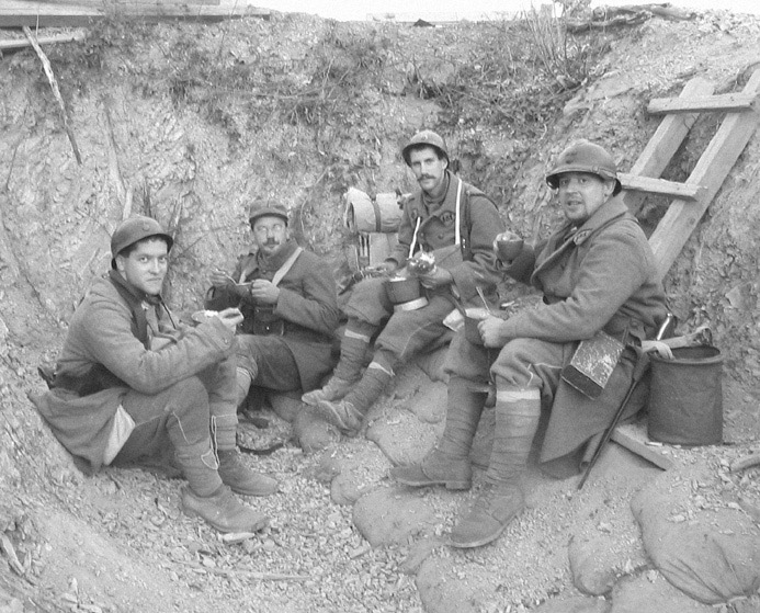 Sdts. Bright and Brun sit down with Sgt. Contamine and Cpl. Picard for supper in the first line trench, November 2005.