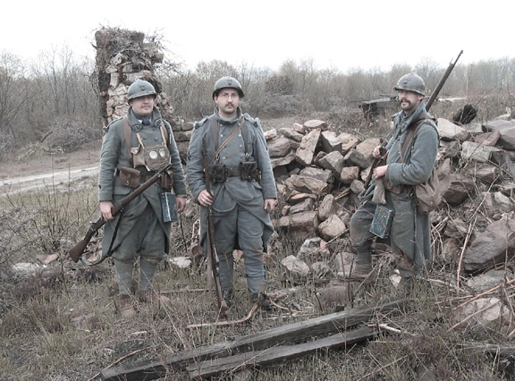 Cpl. Picard, Sdt. Convard and Sgt. Contamine stand amongst the ruins of a destroyed barn, April 2006.