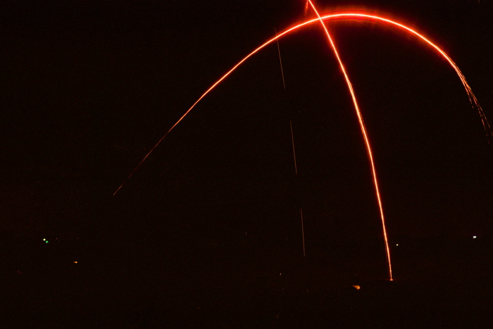 Flares cross paths over a fire-fight. Taken by Garret Miller, April 2010.