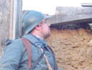 Cpl. Picard peers through a loophole to keep an eye on the enemy, April 2005.
