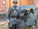 Jean Contamine stands next to one of the famous 75mm canons in a living history at Fort Seclin, France, October 2004.