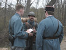 Sgt. Contamine reporting the status of the unit to Capt. William and Lt. Hauser from Battalion staff before heading up to the line, April 2006.