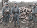 Cpl. Picard, Sdt. Convard and Sgt. Contamine stand amongst the ruins of a destroyed barn, April 2006.