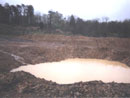 A water-filled shell-hole on the battlefield, April 2006.