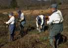 Members of the 151 setting up barbed-wire before the event begins. Newville, November 2013.