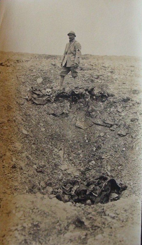 Human remains decomposing in and alongside a shell-hole.
