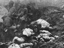Note that the dead French soldiers piled up on the sides of the trench wear the new horizon-blue uniforms while the relieving unit retains the old uniform.